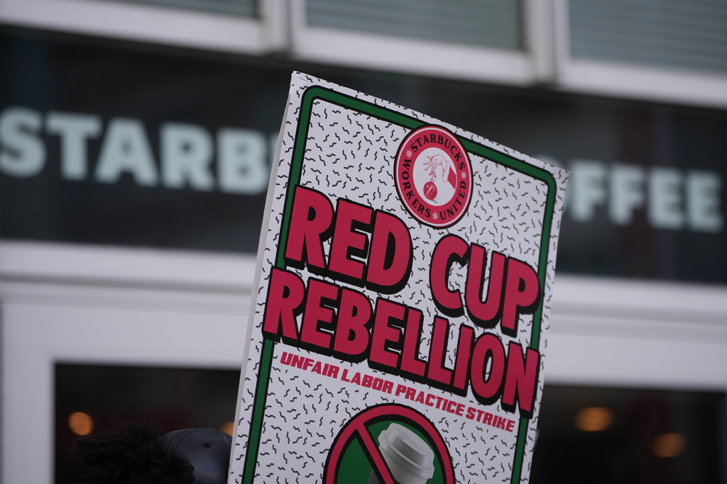 A protester sign is seen during a picket outside a Starbucks, Thursday, Nov. 13, 2025, in Philadelphia. (AP Photo/Matt Slocum)
