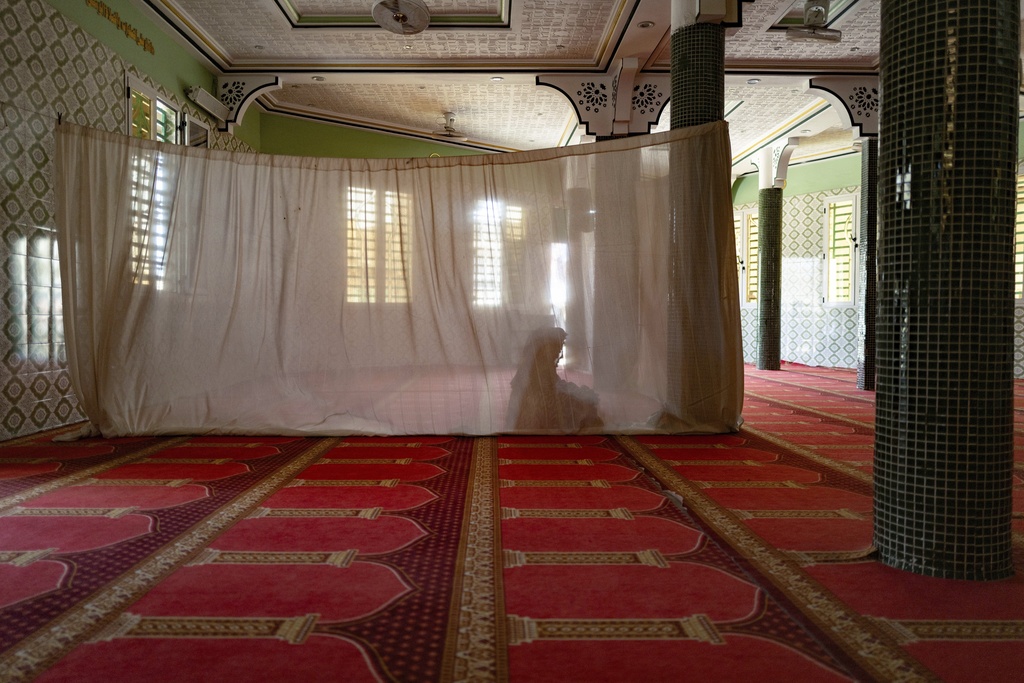 A woman prays in the designated women's section at the Great Mosque of Nietty Mbar in Thiaroye, a suburb of Dakar, Senegal, Friday, July 4, 2025.(AP Photo/Sylvain Cherkaoui)