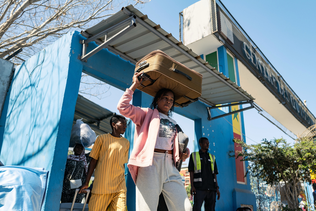 Students carry their belongings as they leave the Cheikh Anta Diop University, which is being evacuated following the death of second year student Abdoulaye Ba, in Dakar Tuesday, Feb. 10, 2026. (AP Photo/Sylvain Cherkaoui)
