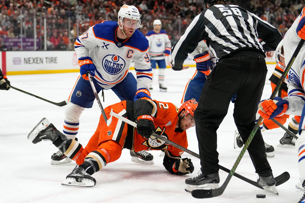 Edmonton Oilers center Connor McDavid, left, and Anaheim Ducks center Tim Washe go after the puck on a face-off during the second period of Game 6 in the first round of the NHL hockey Stanley Cup playoffs series Thursday, April 30, 2026, in Anaheim, Calif. (AP Photo/Mark J. Terrill)