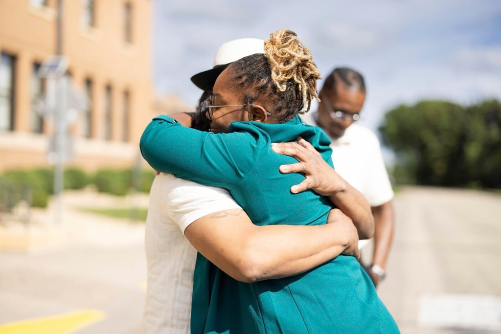Bri'ana Hooper hugs her father, Bryan Hooper Sr., on Thursday, Sept. 4, 2025, outside the Stillwater Correctional Facility in Bayport, Minn. (Emily Baxter via AP)
