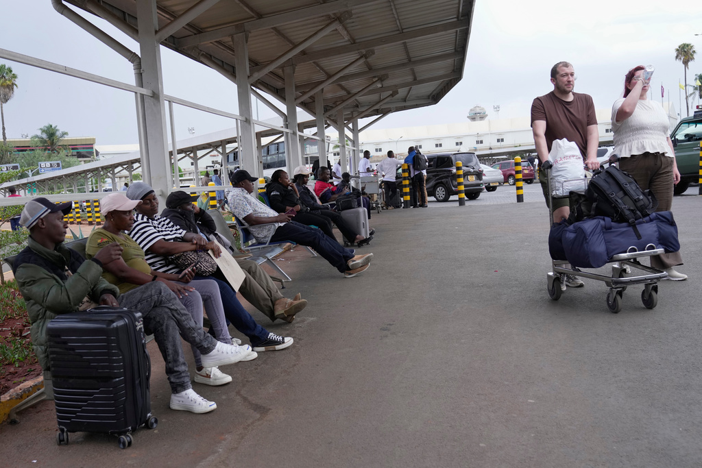 Passengers wait for their delayed flights at Jomo Kenyatta International Airport (JKIA) in Nairobi, Kenya, Monday, Feb. 16, 2026. (AP Photo/Brian Inganga)