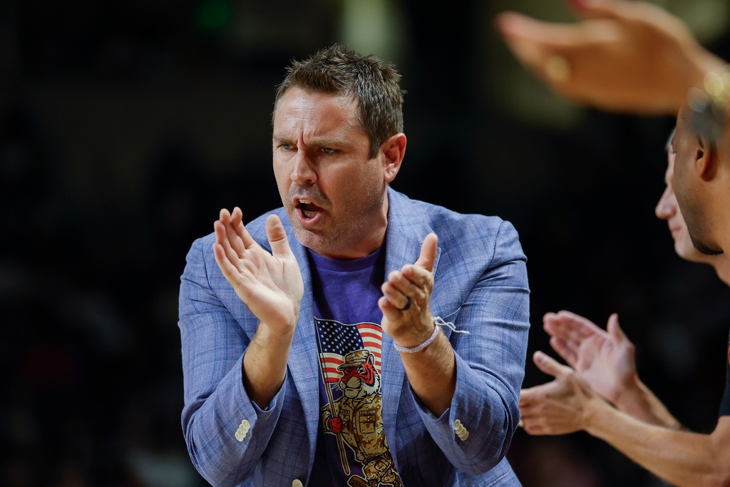 Clemson head coach Shawn Poppie claps during the first half of an NCAA college basketball game against South Carolina in Columbia, S.C., Tuesday, Nov. 11, 2025. (AP Photo/Nell Redmond)