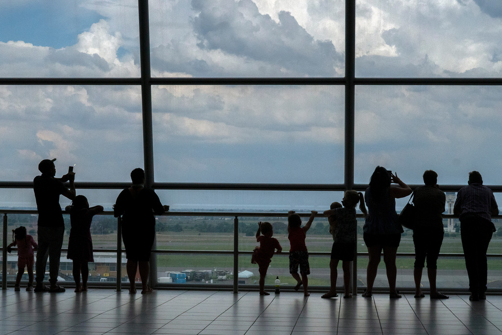 FILE - Families watch planes on the tarmac at Johannesburg's OR Tambo's airport, Monday Nov. 29, 2021. (AP Photo/Jerome Delay, File)