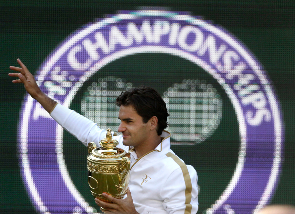 FILE - Roger Federer of Switzerland holds the trophy after defeating Andy Roddick of U.S. in their men's final match on the Centre Court at Wimbledon, July 5, 2009. (AP Photo/Anja Niedringhaus, file)