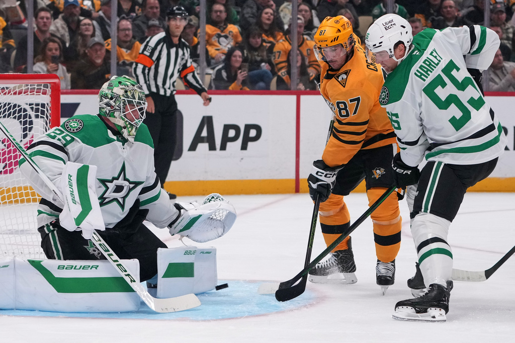 Pittsburgh Penguins' Sidney Crosby (87) cannot shoot past Dallas Stars goaltender Jake Oettinger (29) with Stars' Thomas Harley (55) defending during the second period of an NHL hockey game in Pittsburgh, Saturday, Oct. 10, 2026. (AP Photo/Gene J. Puskar)