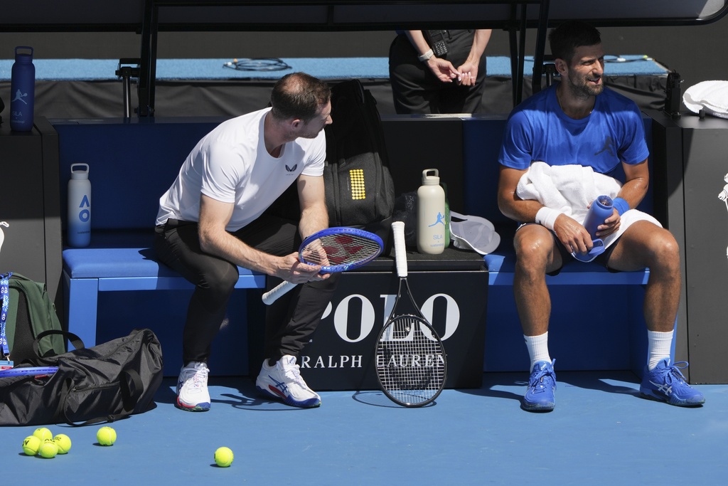 Serbia's Novak Djokovic talks with his coach Andy Murray, left, during a practice session ahead of the Australian Open tennis championship in Melbourne, Australia, Thursday, Jan. 9, 2025. (AP Photo/Mark Baker)