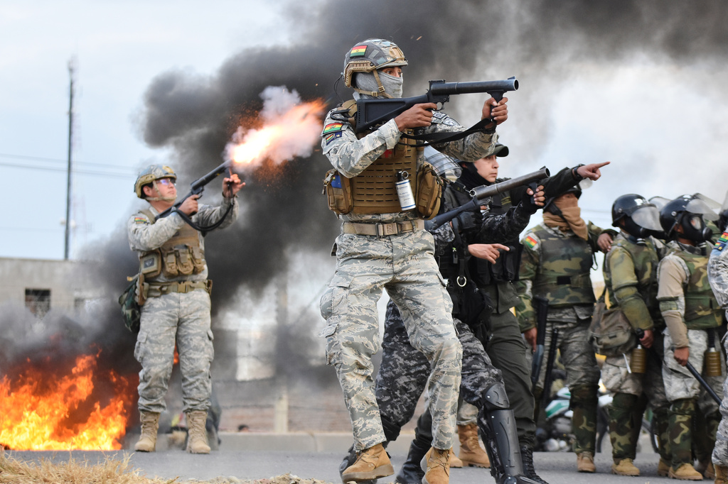 Police fire tear gas at anti-government protesters blocking a highway in Vinto, Bolivia, Monday, June 8, 2026. (AP Photo/Dico Soliz)