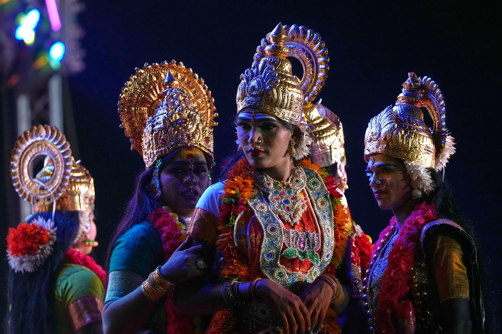 Shanshi, center, and other transgender participants prepare to perform a dance sequence during a beauty pageant at the Koovagam festival in Villupuram, Tamil Nadu, India, Sunday, April 26, 2026. (AP Photo/Mahesh Kumar A.)