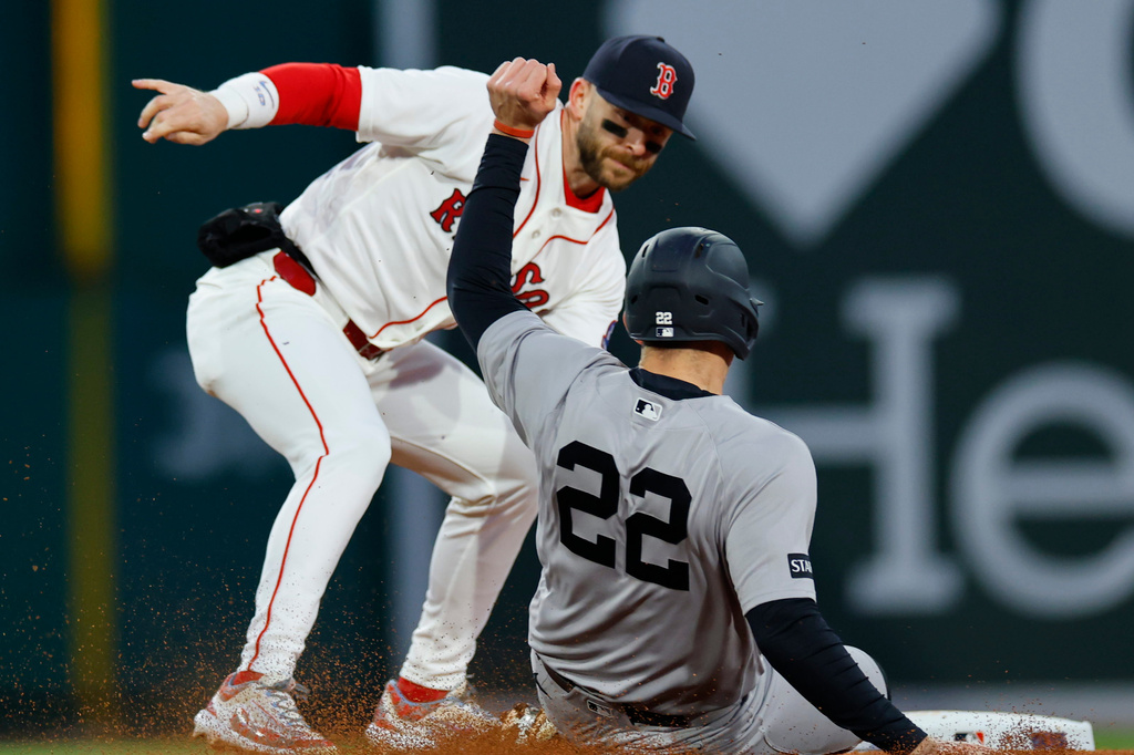 New York Yankees' Ben Rice (22) is tagged out by Boston Red Sox shortstop Trevor Story during the fourth inning of a baseball game, on Tuesday, April 21, 2026, in Boston. (AP Photo/CJ Gunther)