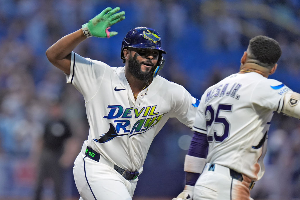 Tampa Bay Rays' Junior Caminero celebrates his two-run home run off Houston Astros pitcher Bryan Abreu with Victor Mesa Jr. (25) during the ninth inning of a baseball game Friday, Sept. 11, 2026, in St. Petersburg, Fla. (AP Photo/Chris O'Meara)