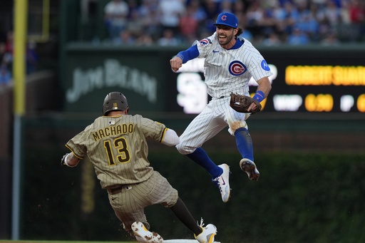 Chicago Cubs' Dansby Swanson leaps over San Diego Padres' Manny Machado to make a play on a ball hit by Jackson Merrill during the sixth inning of Game 3 of a National League wild card baseball game Thursday, Oct. 2, 2025, in Chicago. (AP Photo/Nam Huh) Chicago Cubs' Dansby Swanson leaps over San Diego Padres' Manny Machado to make a play on a ball hit by Jackson Merrill during the sixth inning of Game 3 of a National League wild card baseball game Thursday, Oct. 2, 2025, in Chicago. (AP Photo/Nam Huh)