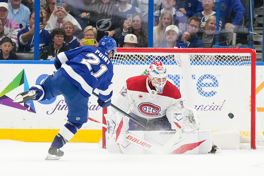 Tampa Bay Lightning center Brayden Point (21) scores past Montréal Canadiens goaltender Jacob Fowler (32) during a shootout in an NHL hockey game Sunday, Dec. 28, 2025, in Tampa, Fla. (AP Photo/Chris O'Meara)