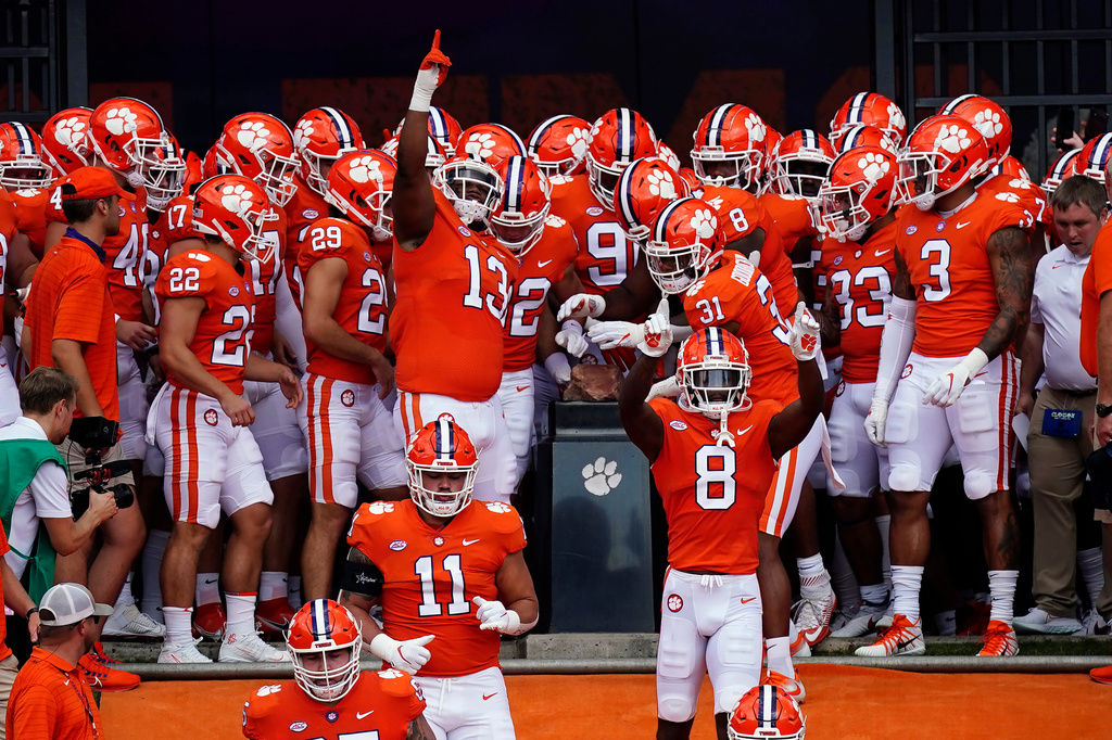 FILE - Clemson players touch Howard's Rock as they run onto the field for an NCAA college football game against Georgia Tech Saturday, Sept. 18, 2021, in Clemson, S.C. (AP Photo/John Bazemore, File)