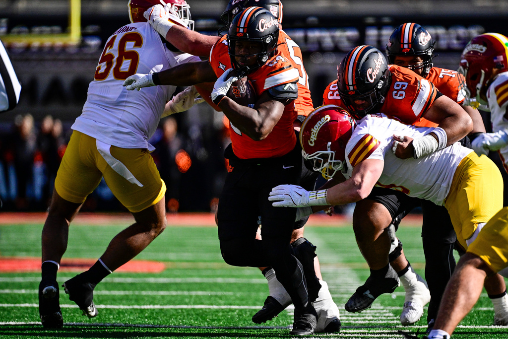 Oklahoma State running back Trent Howland (24) runs against Iowa State during the first half of an NCAA college football game, Saturday, Nov. 29, 2025, in Stillwater, Okla. (AP Photo/Gerald Leong)