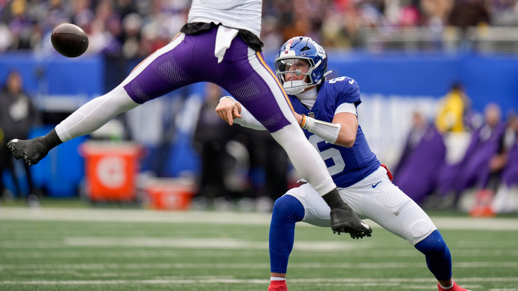 New York Giants quarterback Jaxson Dart (6) passes under pressure against the Minnesota Vikings during the second quarter of an NFL football game, Sunday, Dec. 21, 2025, in East Rutherford, N.J. (AP Photo/Seth Wenig)