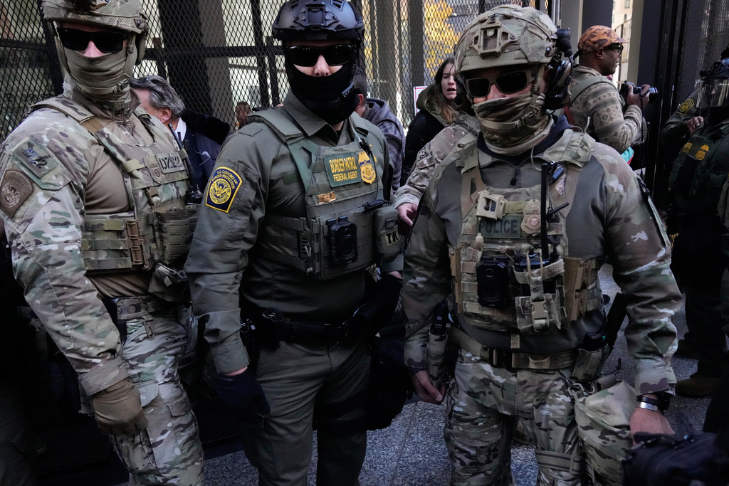 U.S. Customs and Border Patrol agents arrive to escort U.S. Customs and Border Patrol Gregory Bovino from federal court in Chicago, Tuesday, Oct. 28, 2025. (AP Photo/Nam Y. Huh)
