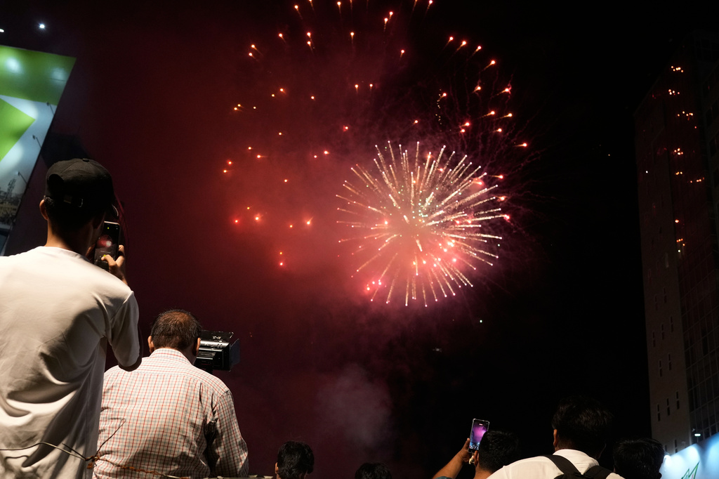People watch fireworks in Lahore, Pakistan, Saturday, Aug. 8, 2026, during celebrations of the signing a trilateral defense agreement between Saudi Arabia, Pakistan and Turkey in Mecca. (AP Photo/K.M. Chaudary)