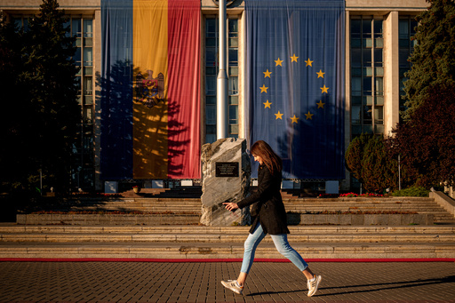 A woman runs in front of the government building, decorated with European Union and Moldovan flags in Chisinau, Moldova, Friday, Sept. 26, 2025, ahead of parliamentary elections taking place on Sept. 28. (AP Photo/Vadim Ghirda) A woman runs in front of the government building, decorated with European Union and Moldovan flags in Chisinau, Moldova, Friday, Sept. 26, 2025, ahead of parliamentary elections taking place on Sept. 28. (AP Photo/Vadim Ghirda)
