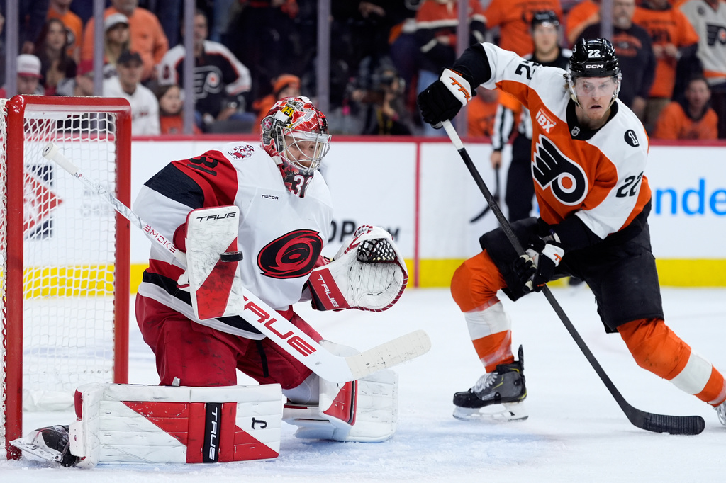 Carolina Hurricanes' Frederik Andersen, left, blocks a shot past Philadelphia Flyers' Christian Dvorak during the second period of Game 3 in the second round of the NHL hockey Stanley Cup playoffs, Thursday, May 7, 2026, in Philadelphia. (AP Photo/Matt Slocum)