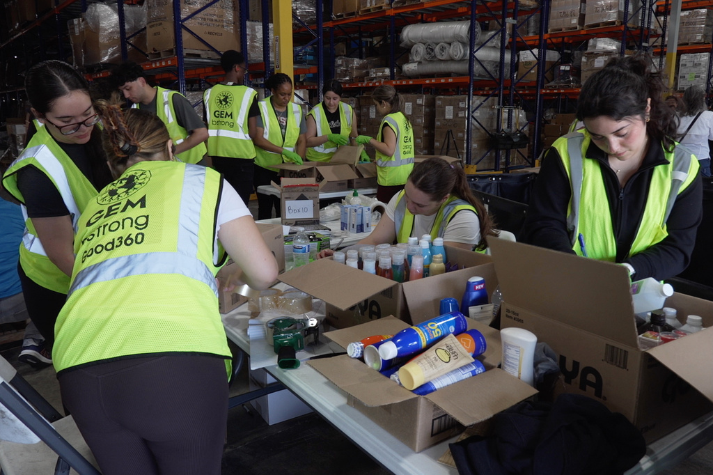 Volunteers are seen packaging supplies, Thursday, June 25, 2026, in Doral, Fla. (AP Photo/Cody Jackson)