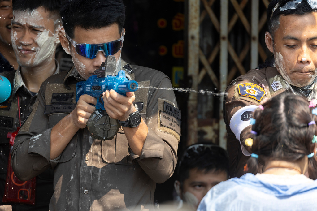 A Thai policeman participates in the Songkran water festival to celebrate the Thai New Year in Prachinburi province, Thailand, Monday, April 13, 2026. (AP Photo/Wason Wanichakorn)