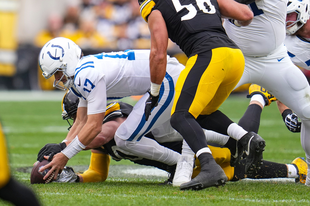 Pittsburgh Steelers linebacker T.J. Watt, rear, recovers fumble by Indianapolis Colts quarterback Daniel Jones (17) during the first half of an NFL football game in Pittsburgh, Sunday, Nov. 2, 2025. (AP Photo/Gene J. Puskar)