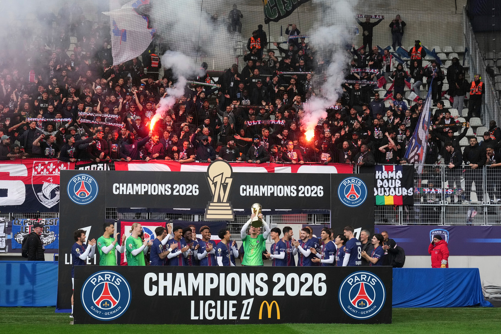 PSG's team players celebrate with the trophy after winning the French League One title, before the French League One soccer match between Paris FC and Paris Saint-Germain in Paris, Sunday, May 17, 2026. (AP Photo/Michel Euler)