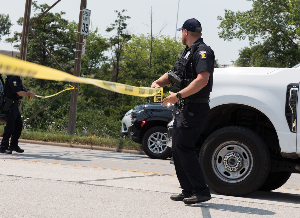 A Toledo police officer sets up a police line while responding to a hazardous material call Wednesday, July 15, 2026, in Toledo, Ohio. (Alex Bracken/The Blade via AP)