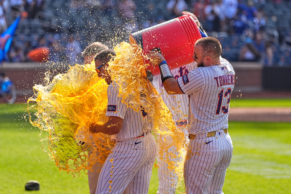 New York Mets' players dump a cooler on Tyrone Taylor, left, after a baseball game against the New York Yankees, Sunday, May 17, 2026, in New York. (AP Photo/Seth Wenig)