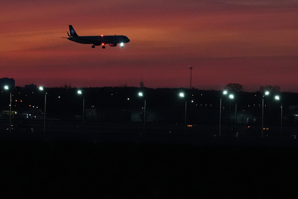 An airplane descends into landing at O'Hare International Airport in Chicago, Wednesday, Nov. 12, 2025. (AP Photo/Nam Y. Huh)