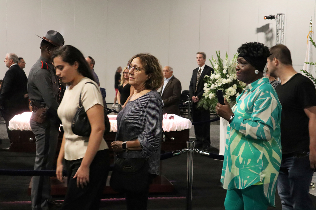 Freida Adams, right, pays her respects former Judge Frank Caprio at his visiting hours at the Rhode Island Convention Center in Providence, R.I. on Thursday, Aug. 28, 2025. (AP Photo/Leah Willingham)