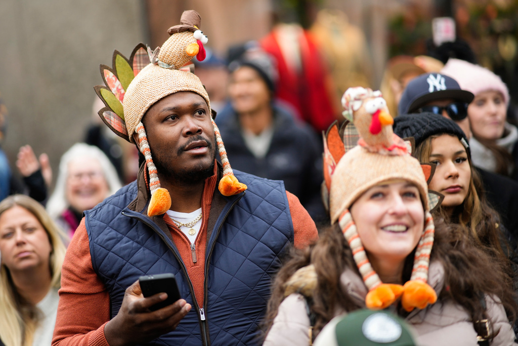 Spectators watch as balloons and floats pass on Sixth Avenue during the Macy's Thanksgiving Day Parade, Thursday, Nov. 27, 2025, in New York. (AP Photo/Eduardo Munoz Alvarez)