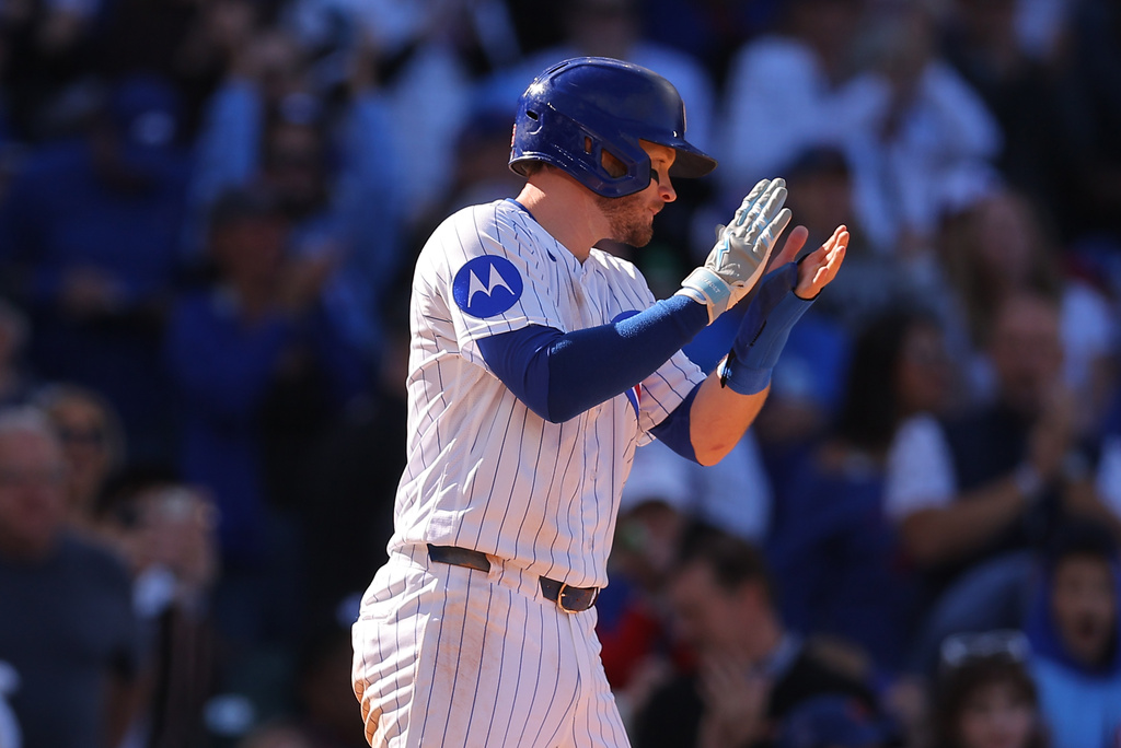 Chicago Cubs' Ian Happ celebrates after scoring on Nico Hoerner's RBI single during the sixth inning of a baseball game against the Miami Marlins, Thursday , Sept. 24, 2026, in Chicago. (AP Photo/Melissa Tamez)
