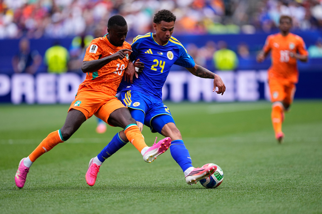 Ivory Coast's Nicolas Pepe (19) and Curaçao's Deveron Fonville (24) fight for the ball during the World Cup Group E soccer match between Curacao and Ivory Coast in Philadelphia, Thursday, June 25, 2026. (AP Photo/Petr David Josek)