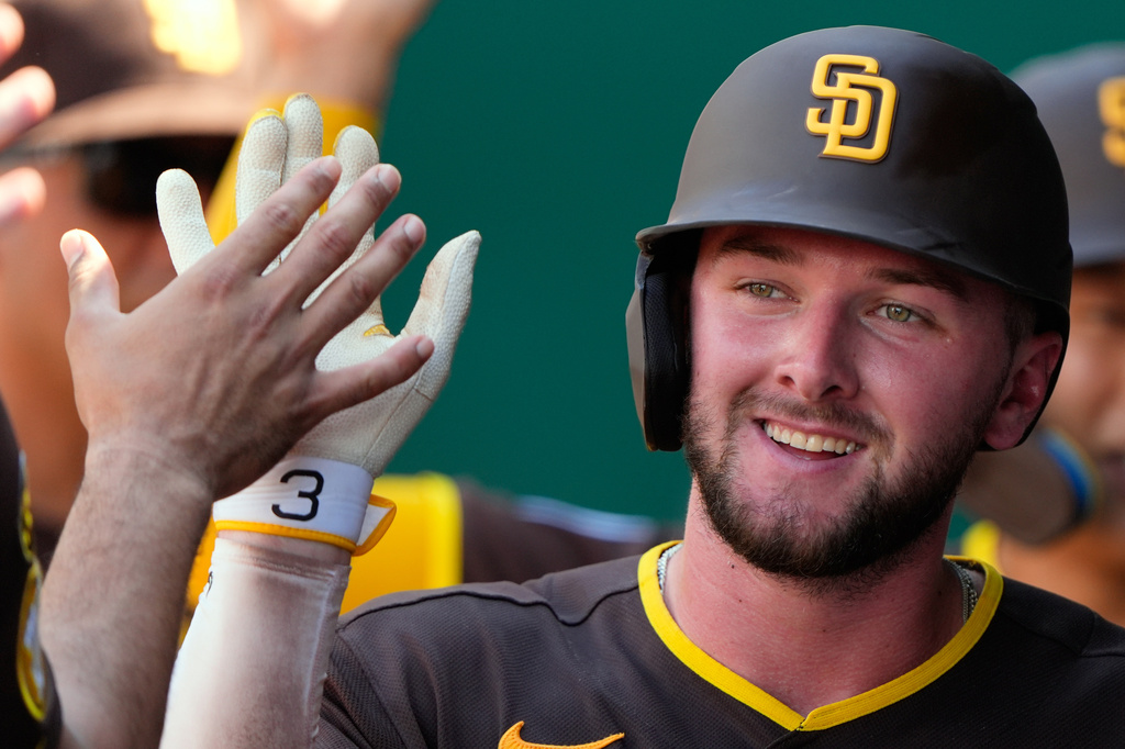 San Diego Padres' Jackson Merrill celebrates in the dugout after hitting a two-run home run during the ninth inning of a baseball game against the Kansas City Royals, Sunday, July 19, 2026, in Kansas City, Mo. (AP Photo/Charlie Riedel)