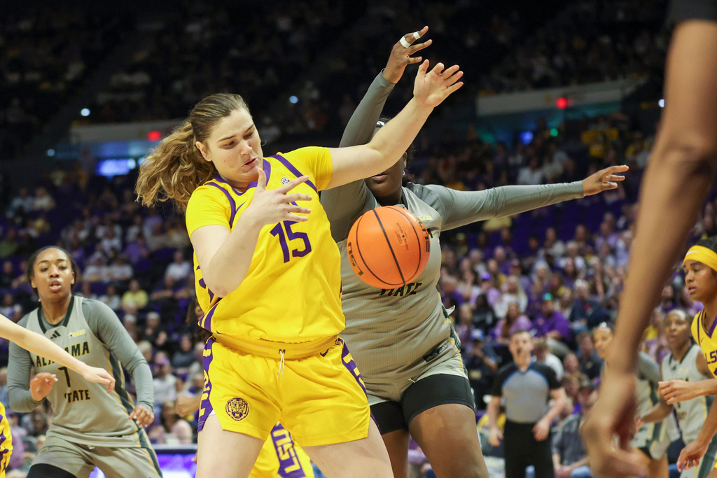 LSU forward Meghan Yarnevich (15) and Alabama State center Jacqueline Osei, right, both go after a loose ball in the first half of an NCAA college basketball game in Baton Rouge, La., Sunday, Dec. 28, 2025. (AP Photo/Peter Forest)