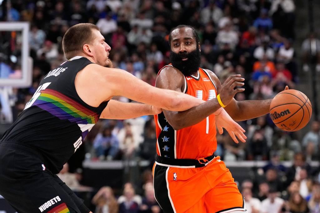 Denver Nuggets center Nikola Jokic, left, reaches in on Los Angeles Clippers guard James Harden during the second half of an NBA basketball game Wednesday, Nov. 12, 2025, in Inglewood, Calif. (AP Photo/Mark J. Terrill)