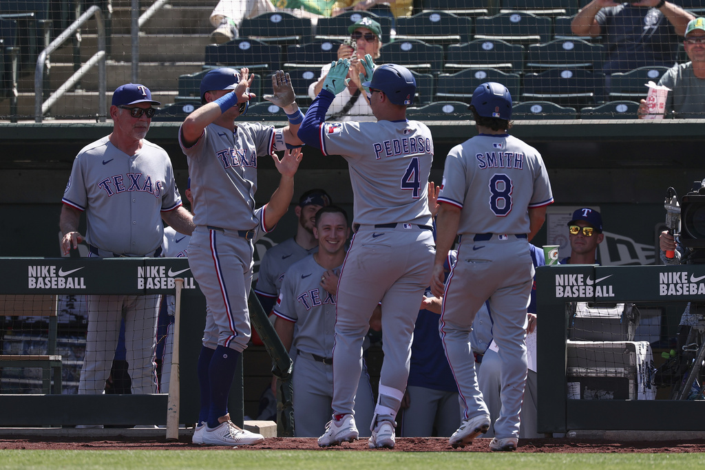 Texas Rangers' Joc Pederson (4) celebrates after hitting a two-run home run during the first inning of a baseball game against the Athletics, Sunday, Aug. 31, 2025, in West Sacramento, Calif. (AP Photo/Sara Nevis)
