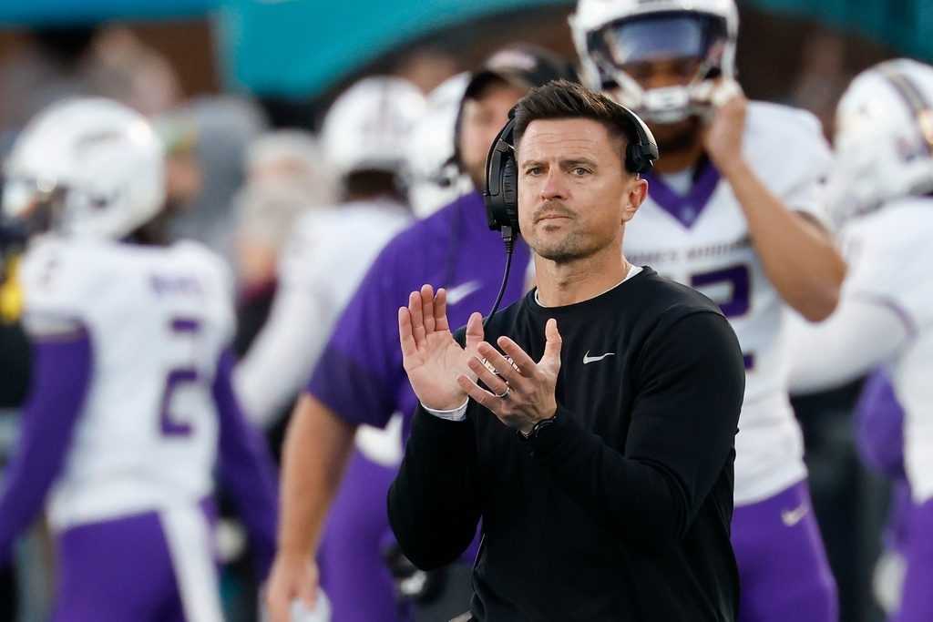 James Madison head coach Bob Chesney claps after his team made a field goal against Coastal Carolina during the first half of an NCAA college football game in Conway, N.C., Saturday, Nov. 29, 2025. (AP Photo/Nell Redmond)