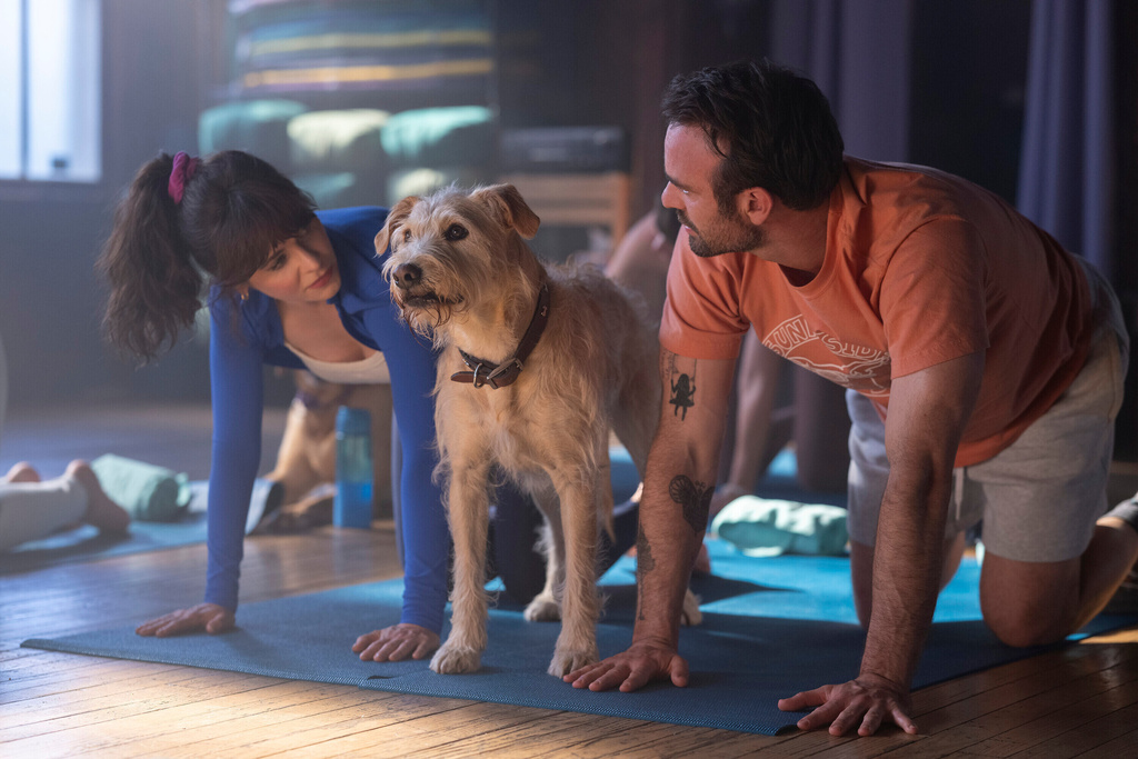 This image released by Amazon Content Services shows Zooey Deschanel, left, and Charlie Cox in a scene from "Merv." (Wilson Webb/Amazon Content Services via AP)