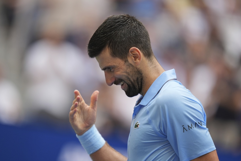 Novak Djokovic, of Serbia, reacts afer winnning a point against Carlos Alcaraz, of Spain, during the men's singles semifinals of the U.S. Open tennis championships, Friday, Sept. 5, 2025, in New York. (AP Photo/Seth Wenig)