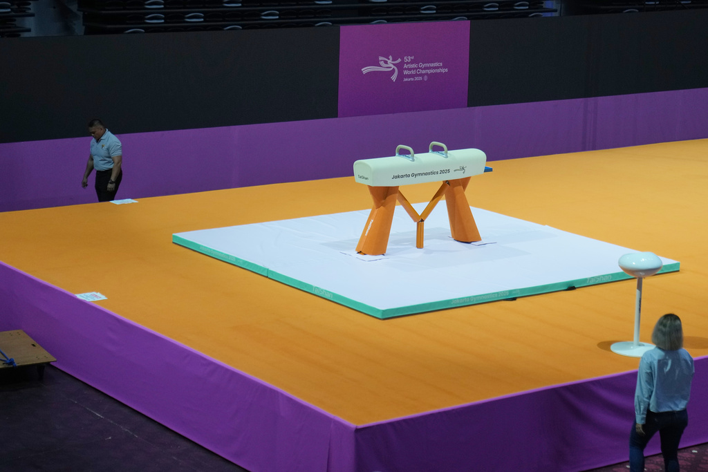 A security guard walks past a pommel horse at the venue prepared for the Artistic Gymnastics World Championships at Indonesia Arena in Jakarta, Indonesia, Friday, Oct. 10, 2025. (AP Photo/Dita Alangkara)