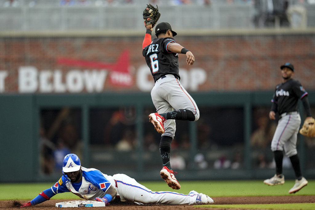 Atlanta Braves' Michael Harris II (23) steals second base against Miami Marlins' Otto Lopez (6) in the second inning in the second baseball game of a doubleheader, Saturday, Aug. 9, 2025, in Atlanta. (AP Photo/Mike Stewart)