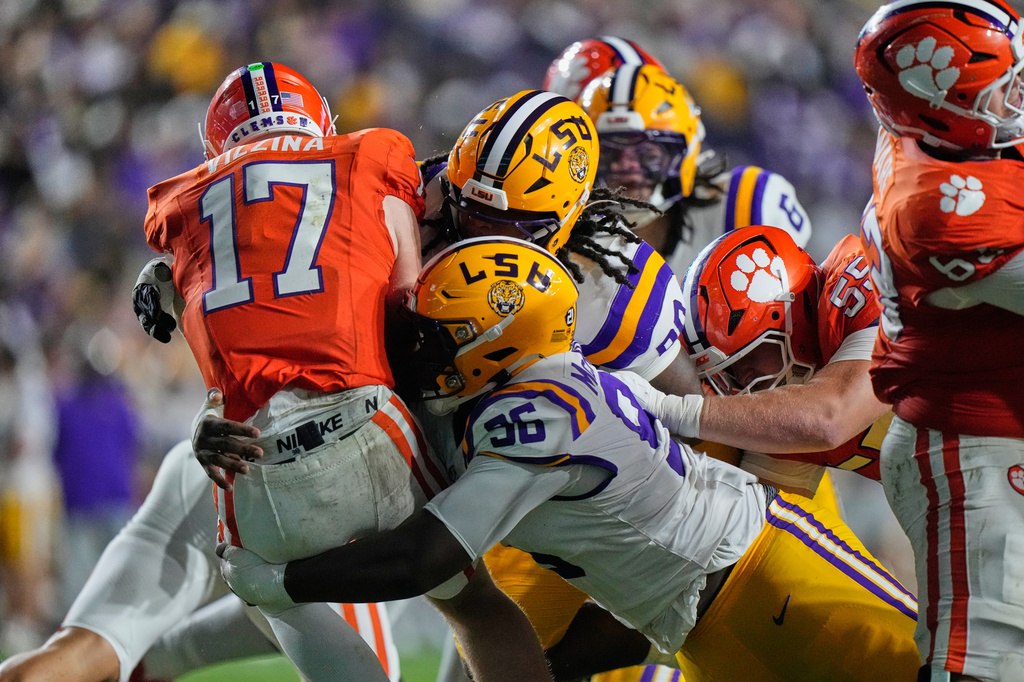 Clemson quarterback Christopher Vizzina (17) is sacked by LSU defensive tackle Dominick McKinley (96) and defensive tackle Stephiylan Green (90) in the first half of an NCAA college football game, Saturday, Sept. 5, 2026 in Baton Rouge, La. (AP Photo/Gerald Herbert)