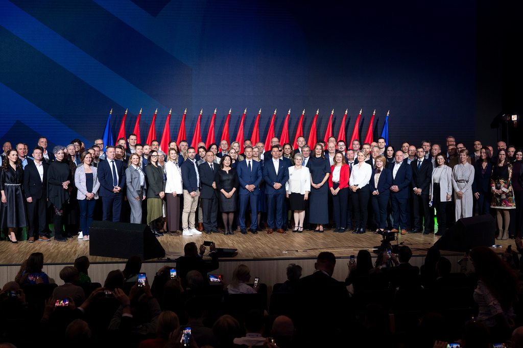 Péter Magyar, center, leader of the opposition Tisza party who will challenge Prime Minister Viktor Orbán in national elections on April 12. poses for a group photo with all the candidates of the party, after their campaign opener event in Budapest, Hungary on Sunday, Feb. 15, 2026. (AP Photo/Denes Erdos)