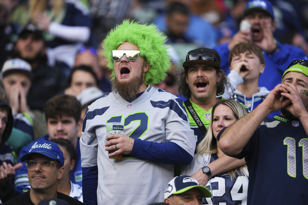 Seattle Seahawks fans cheer in the second half of an NFL football game against the New Orleans Saints, Sunday, Sept. 21, 2025, in Seattle. (AP Photo/Lindsey Wasson)