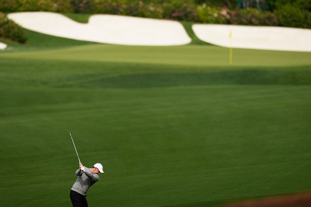 Rory McIlroy, of Northern Ireland, hits from the fairway on the 13th hole during a practice round ahead of the Masters golf tournament at the Augusta National Golf Club, Tuesday, April 7, 2026, in Augusta, Ga. (AP Photo/David J. Phillip)