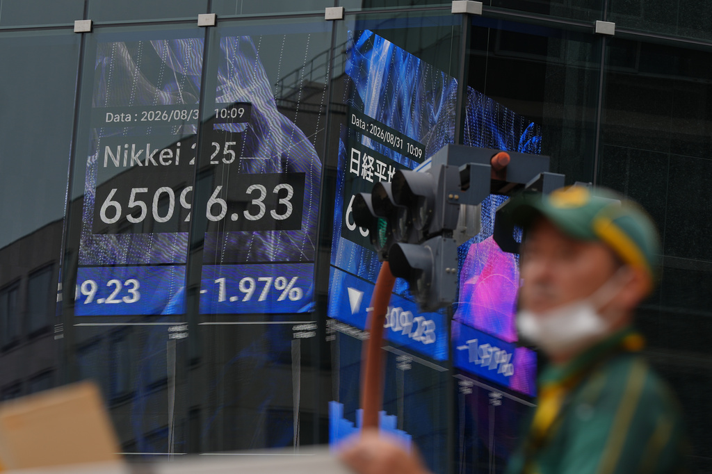A person walks in front of an electronic stock board showing Japan's Nikkei index at a securities firm Monday, Aug. 31, 2026, in Tokyo. (AP Photo/Eugene Hoshiko)