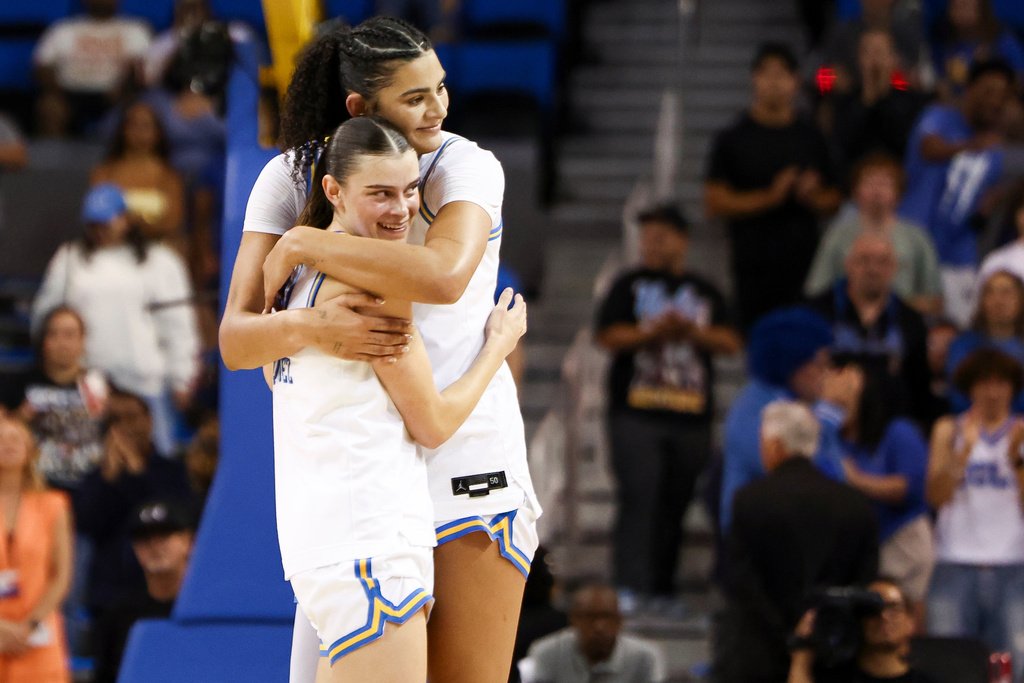 UCLA center Lauren Betts, right, and forward Gabriela Jaquez, left, embrace against Oklahoma State during the second half in the second round of the NCAA college basketball tournament, Monday, March 23, 2026, in Los Angeles. (AP Photo/Jessie Alcheh)